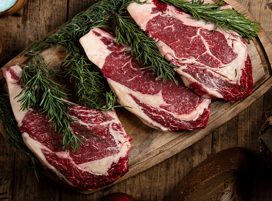 Meat and eggs on wooden cutting board